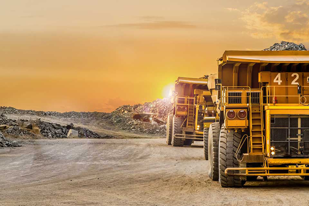 A fleet of heavy duty trucks at a minning site.